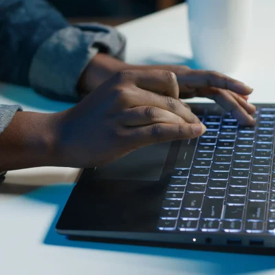 teleworker-working-from-home-typing-laptop-keyboard-close-up teleworker-working-from-home-typing-laptop-keyboard-close-up