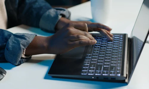 teleworker-working-from-home-typing-laptop-keyboard-close-up